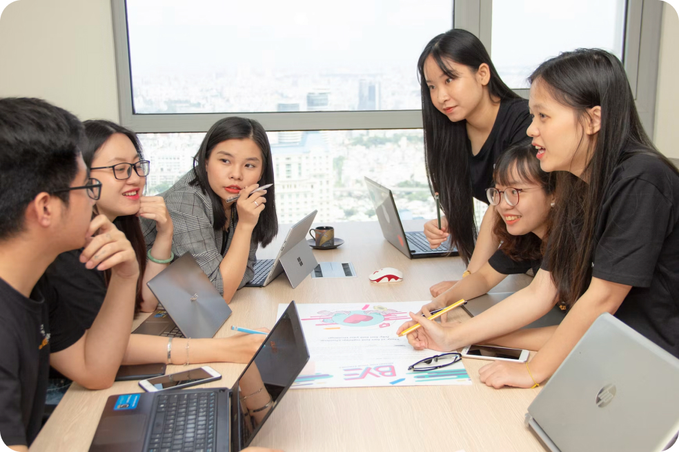 A team of builders and educators collaborating around a table